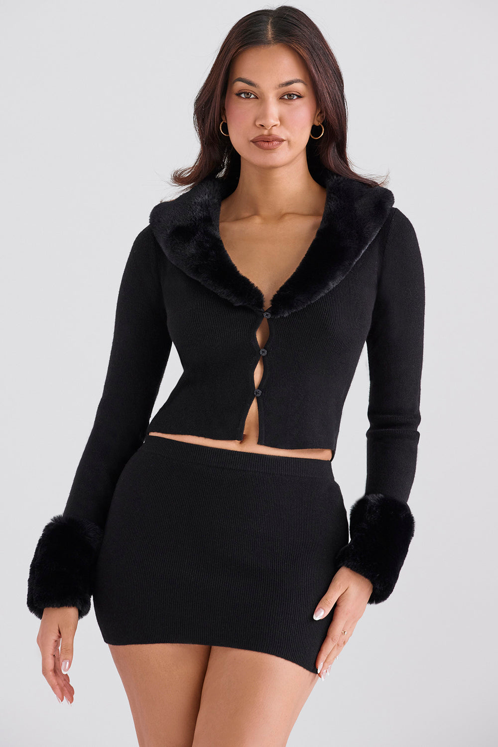 Black cardigan with faux fur trim and cashmere mini skirt