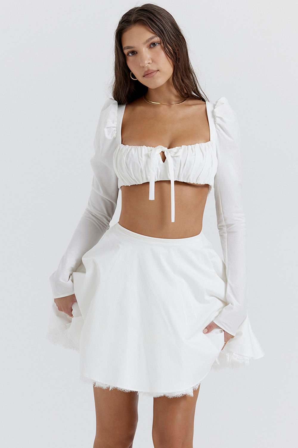 White top with puff sleeves and mini skirt with bow